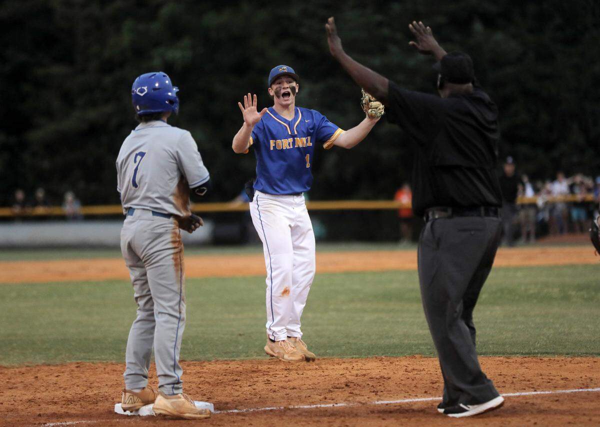 Fort Mill’s Eli Craddock protests after an umpire calls Berkley’s Jack Hedges safe at third base.