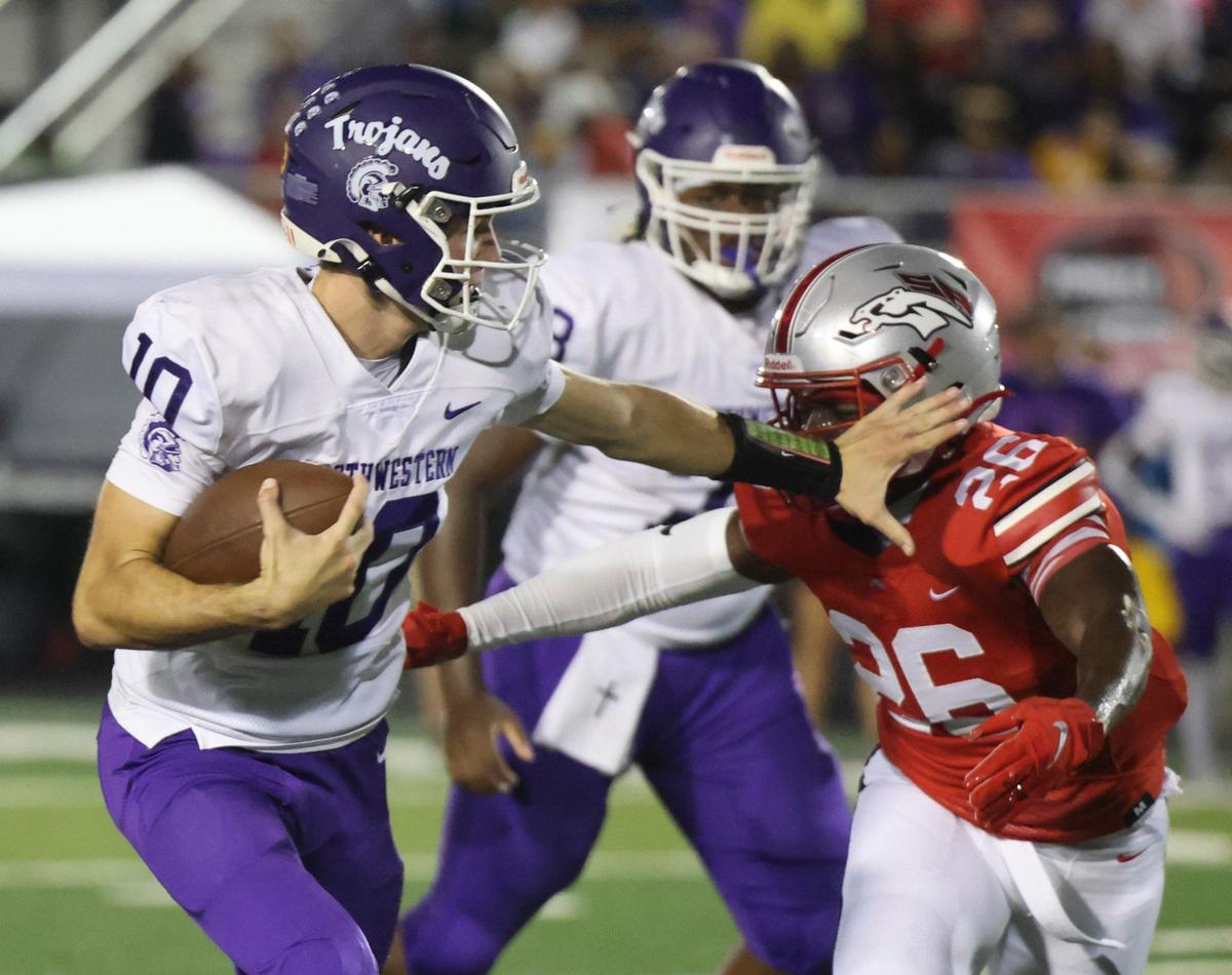 Northwestern’s Finley Polk tries to keep South Pointe’s Dequan Evans away Friday as the Stallions and Trojans compete in Rock Hill.