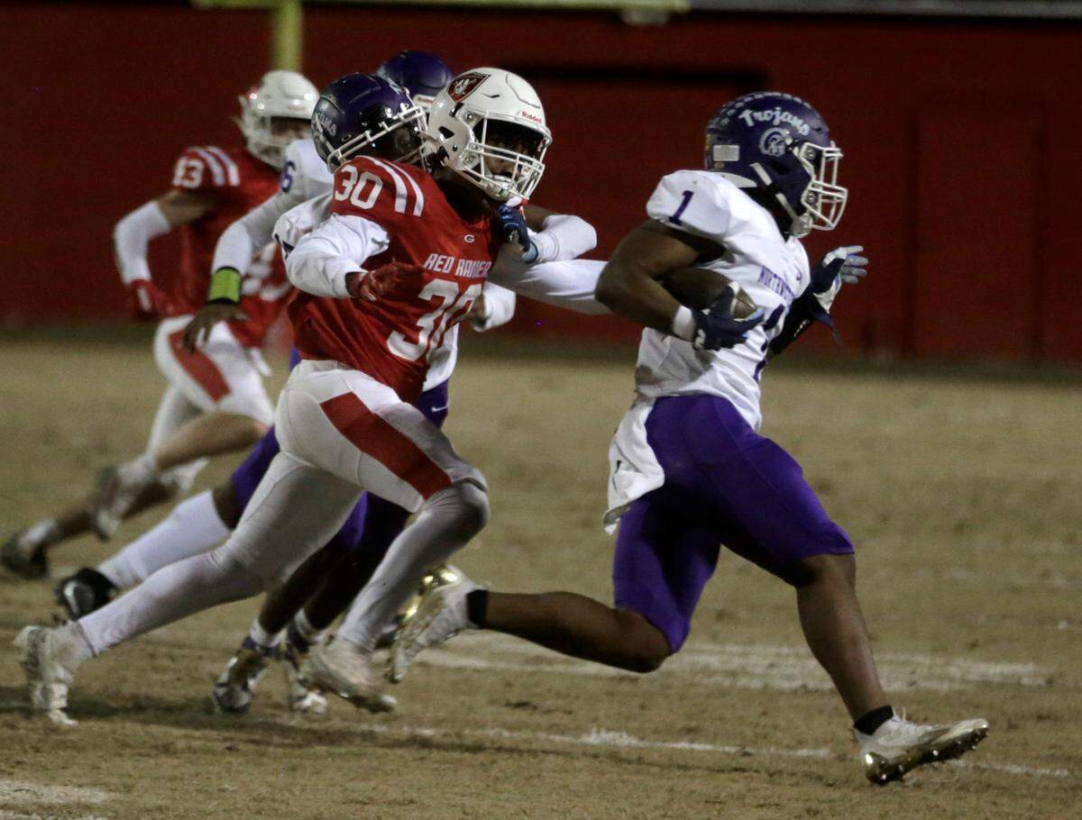 Northwestern’s Turbo Richard carries the ball as Greenville’s Preston Lounds (30) follows Friday at the Class 4A Upperstate Championship game in Greenville, S.C.