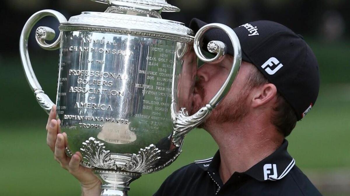Jimmy Walker kisses the Wanamaker Trophy after winning the PGA Championship Sunday at Baltusrol Golf Club in Springfield, N.J. Walker shot a bogey-free 3-under 67 in the final round to hold off Jason Day by a stroke.
