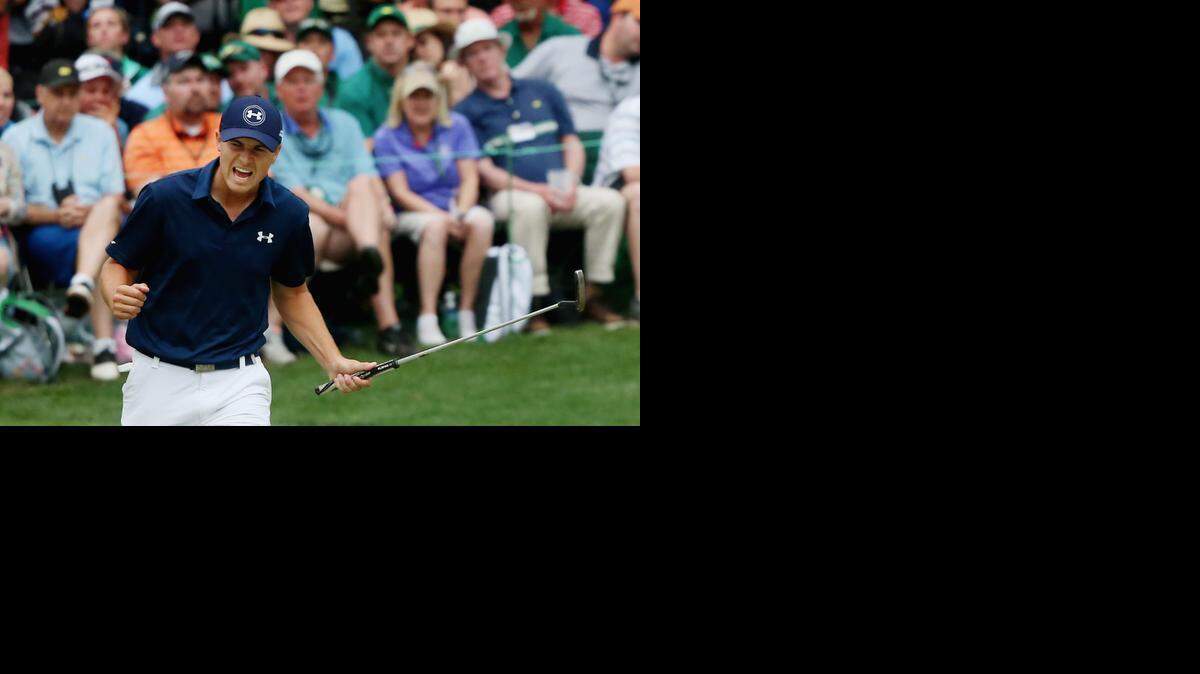 
Jordan Spieth reacts to a par-saving putt on the 16th green during the final round of the 2015 Masters Tournament at Augusta National Golf Club. 
