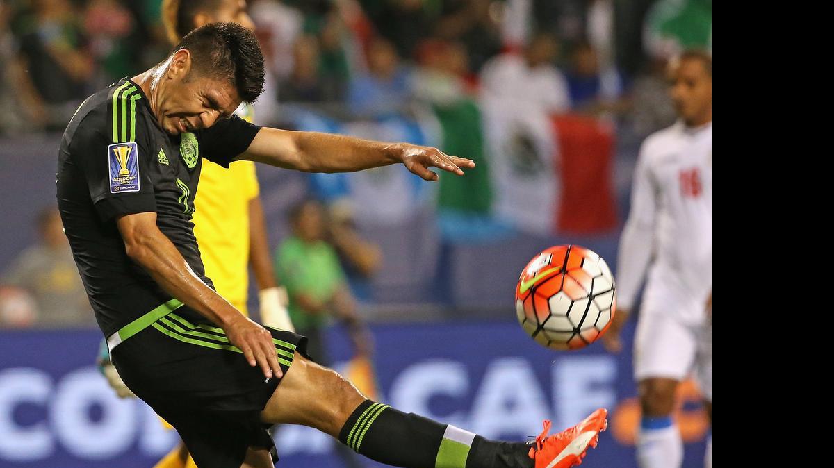 
Mexico’s Oribe Peralta kicks the ball after scoring a goal against Cuba during a match in the 2015 CONCACAF Gold Cup at Soldier Field on July 9, 2015 in Chicago.


