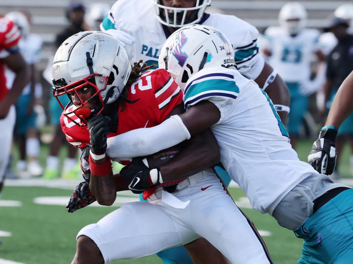 South Pointe’s Tacarean Douglas is brought down by Palisades’ Zaiden Palyor Friday at the WRHI Football City USA scrimmage in Rock Hill.