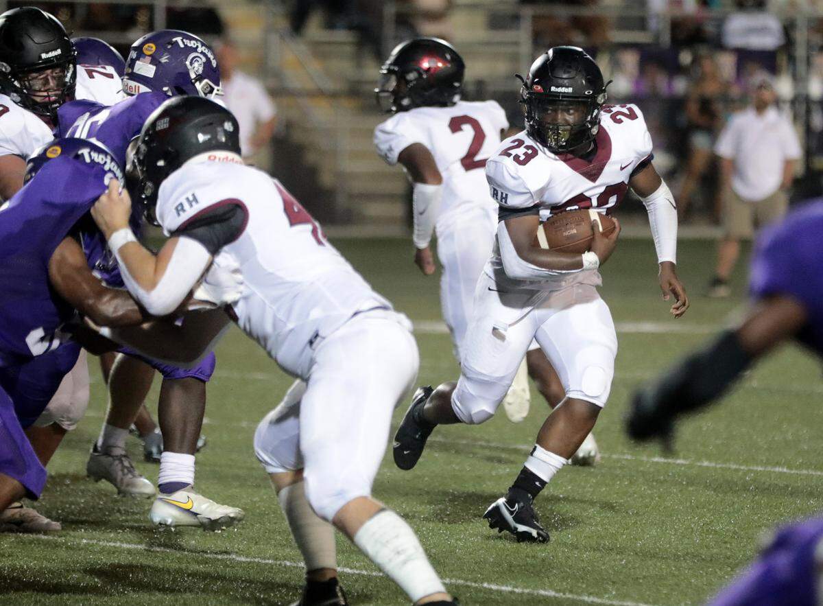 Rock Hill’s Brandon Watson carries the ball Friday as the Bearcats compete with cross-town rival Northwestern Trojans.