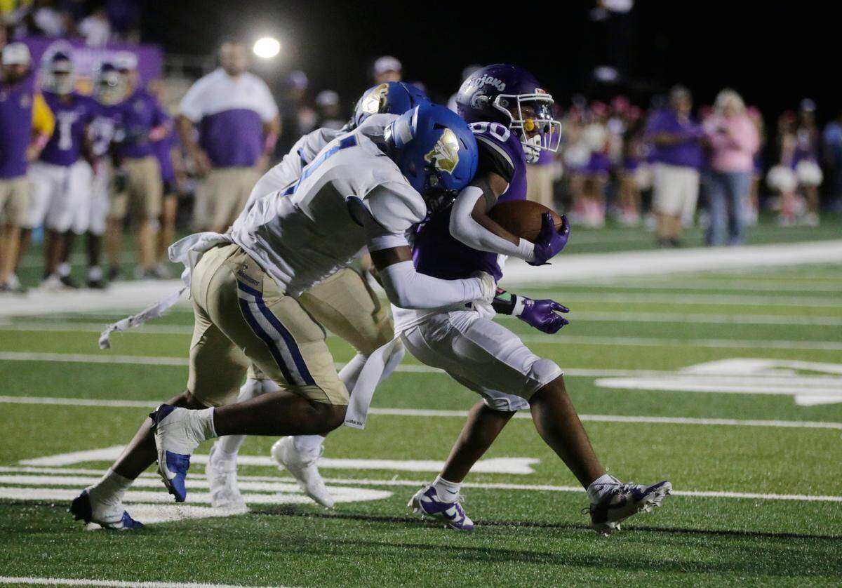 Indian Land’s Omarion Davis tries to bring down Northwestern’s Kameron Vance.
