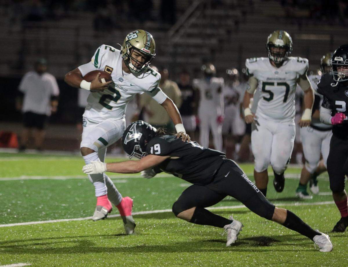 York’s Ashton Edington tries to stop Catawba Ridge quarterback Jadyn Davis Friday in York.
