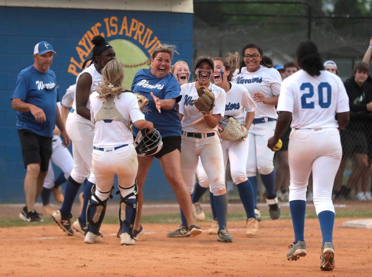The Indian Land girls softball team and coach Monica Barfield celebrate after winning against Lugoff-Elgin Monday in Indian Land