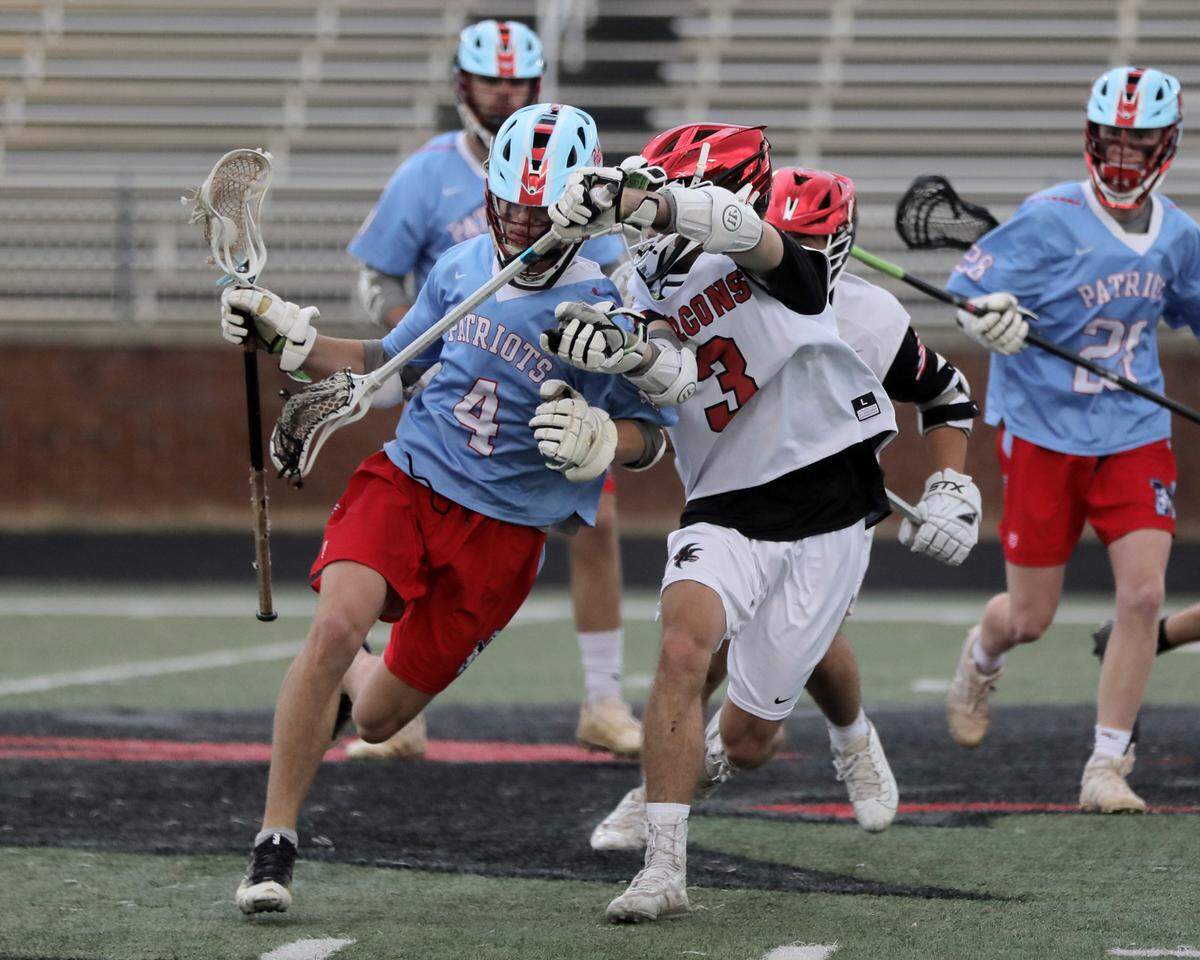 Nation Ford’s Tyler Demarco (3) goes on the attack against J.L. Mann’s Peston Davis (4).