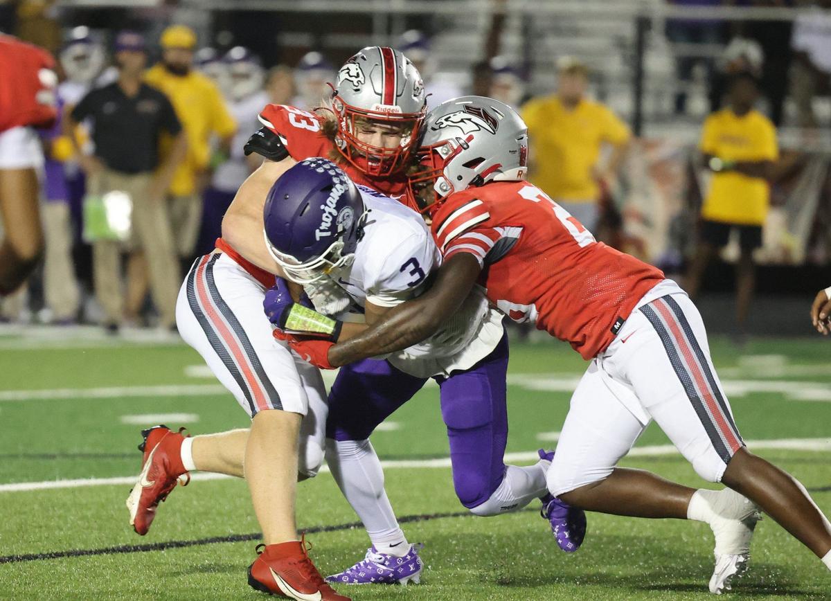 Northwestern’s Kameron Vance (3) is brought down by South Pointe’s Brysen Ginn, left, and Dequan Evans.