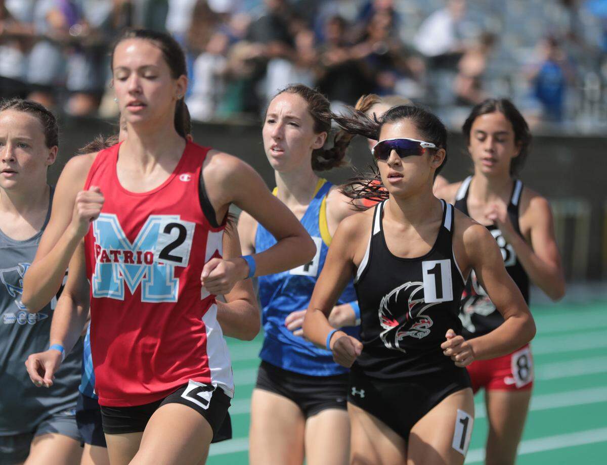 Nation Ford’s Katie Pou (1) competes in the 1600 meter dash Saturday at the 5A track and field state championships in Columbia.