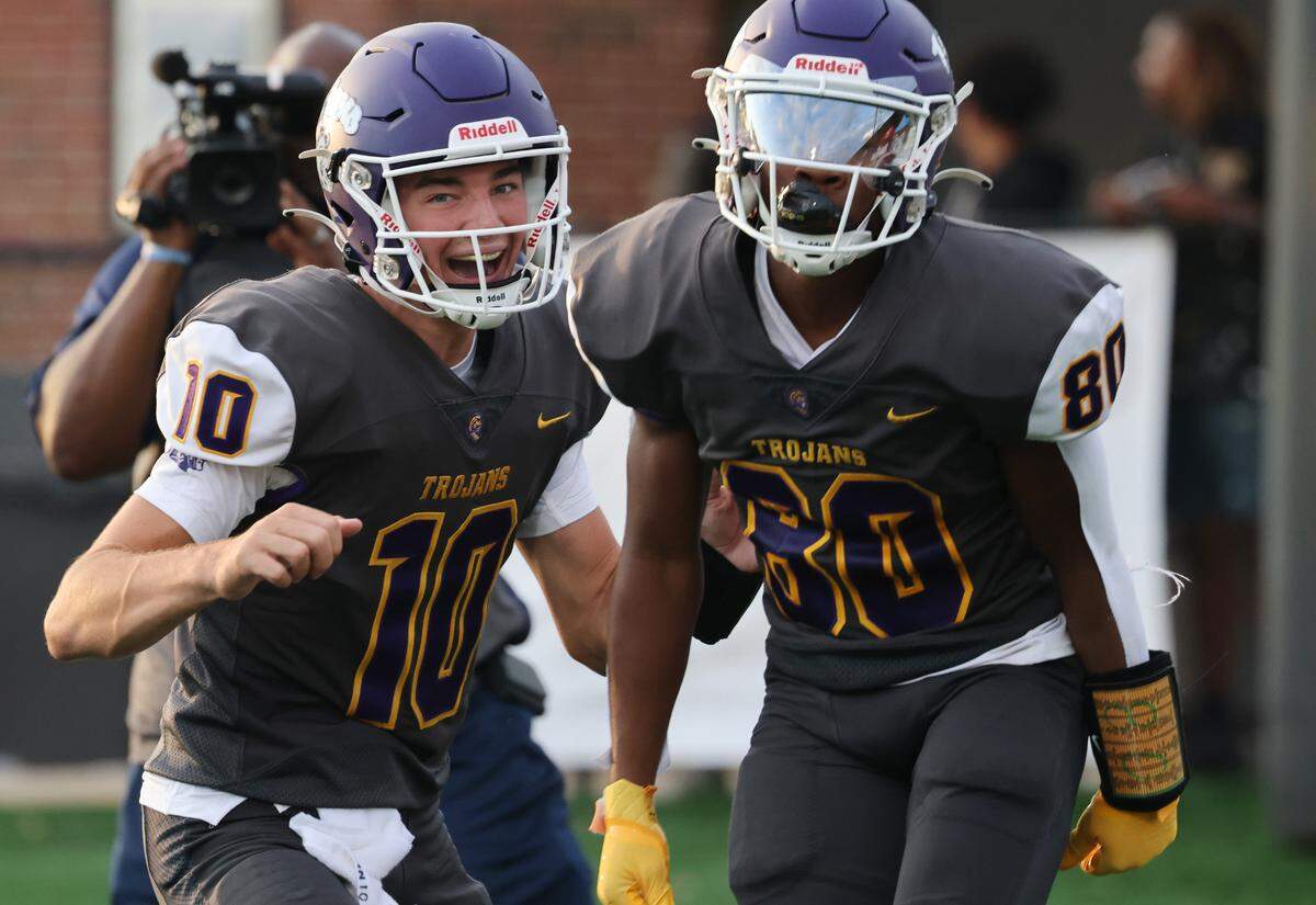 Northwestern quarterback Finley Polk (10) and Kameron Vance celebrate after Vance scores a touchdown Friday, Aug. 11, 2023.