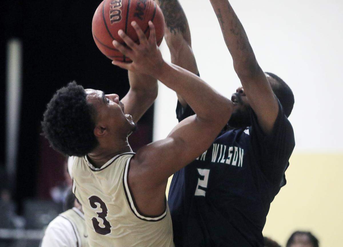 Clinton’s Jermirian Davis (3) shoots over Warren Wilson’s DeMarco Jackson.