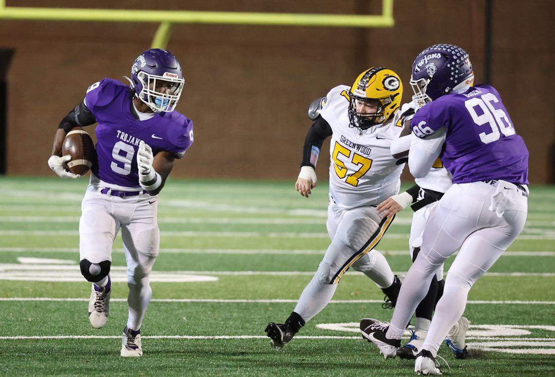 Northwestern’s Will Massey carries the ball against Greenwood’s Jordan Thompson (57) as Northwestenr’s Mason Grier defends Friday in Rock Hill, S.C.