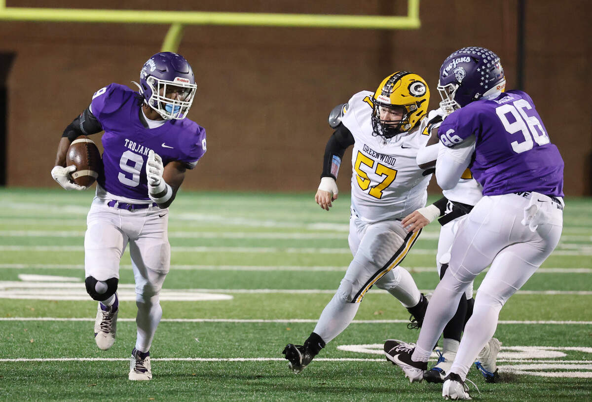 Northwestern’s Will Massey carries the ball against Greenwood’s Jordan Thompson (57) as Northwestenr’s Mason Grier defends Friday in Rock Hill, S.C.