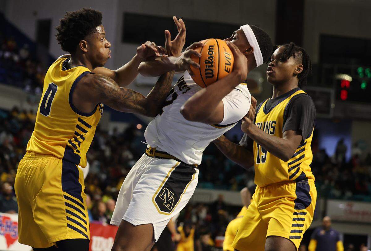 Lancaster’s Jordan Watford, left, North Augusta’s Jamison Mckenzie, center, and Lancaster’s Niquan White struggle for the ball Friday at the Class 4A state championships in Florence