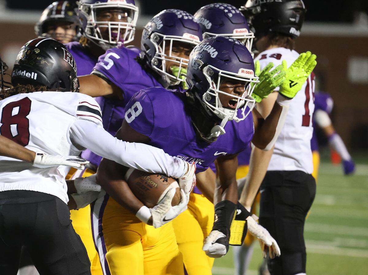 Northwestern’s Zymier Gordon-Miles (8) celebrates after gaining possession of the ball Friday, Oct. 18, 2024 as the Trojans take on cross-town rival Rock Hill High School
