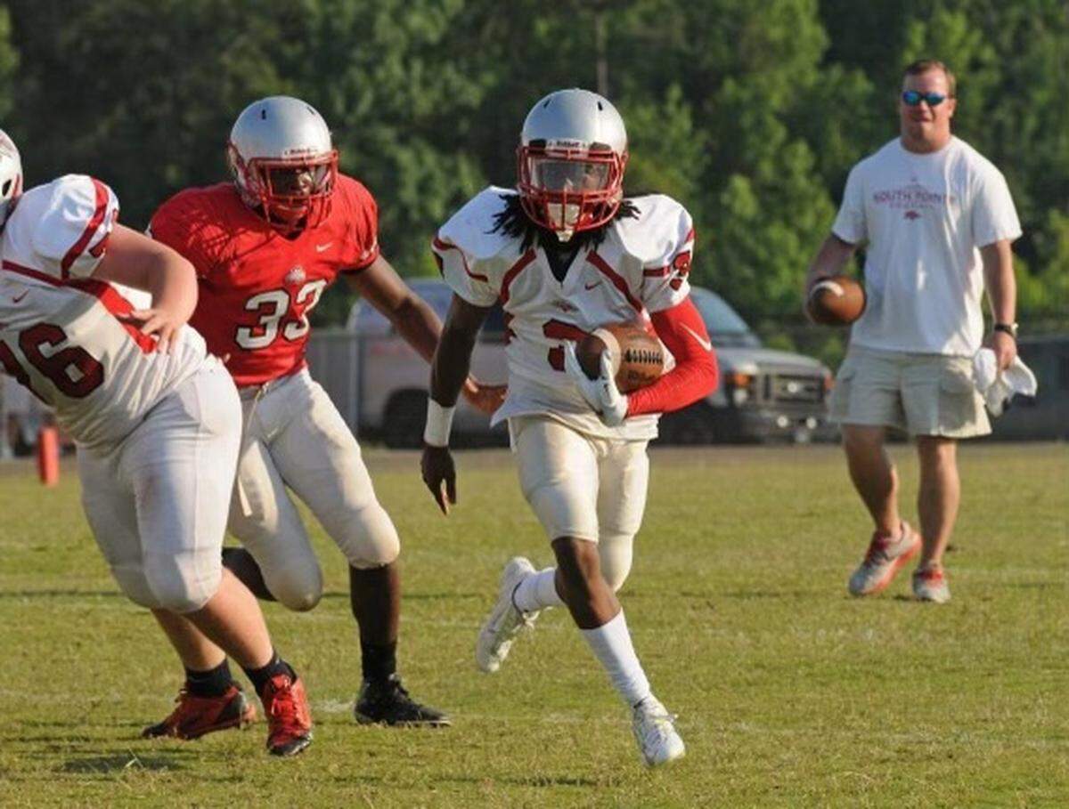 Steven Gilmore Jr. (white jersey, carrying ball) helped lead South Pointe to four-straight football state titles.