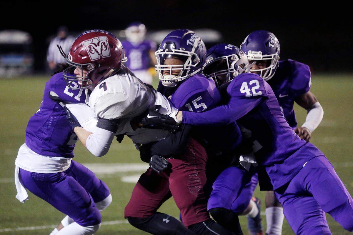 Westside’s Jameson Wilson (9) is brought down by Northwestern’s Justin Spencer (21), Jammar Perry (15) and Trevor Shick (42) during the 3rd round AAAA playoff game in Rock Hill on Friday, Nov. 18, 2022.