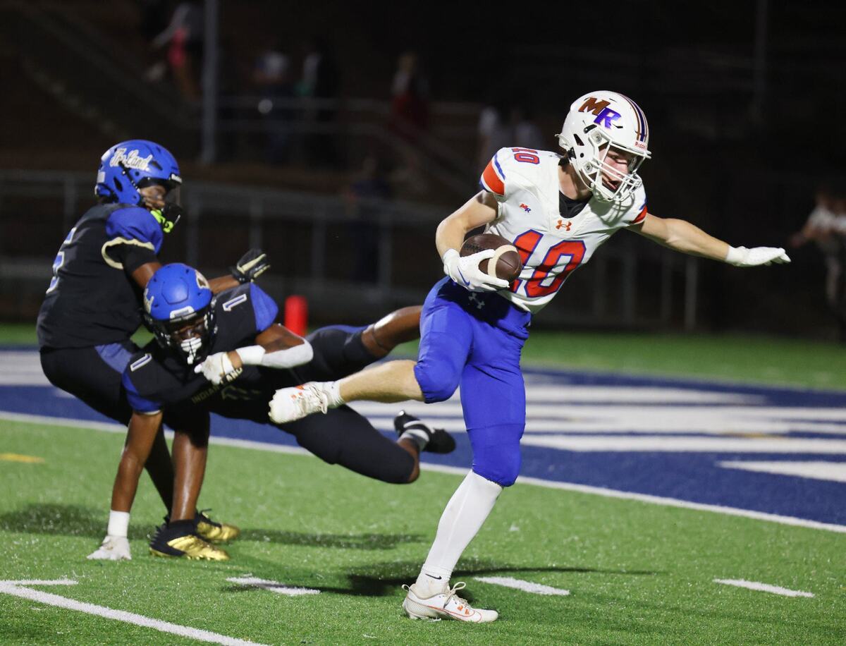 Marvin Ridge’s Levi Haines heads to the end zone against Indian Land’s Omarion Davis (1) and Devon Caldwell.