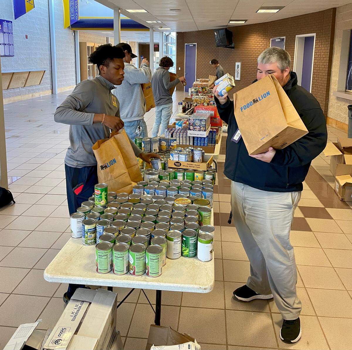 High school athletes and coaches at Northwestern High School helped pack 50 of 150 meals the Rock Hill school district distributed to families in need on Wednesday, Dec. 22, 2021.