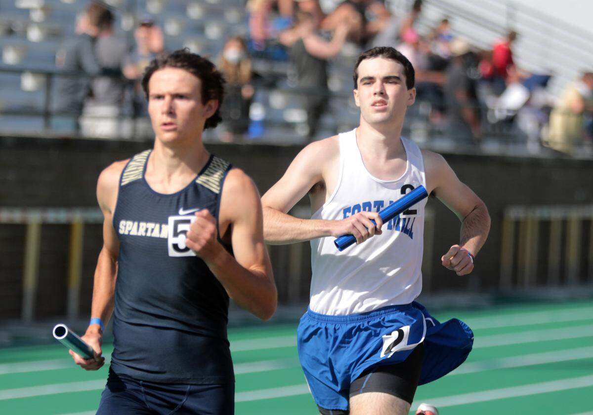 Fort Mill’s Jackson Dawson, right, and Spartanburg’s John Bolinger compete in the 4x800 relay Saturday at Spring Valley High School at the 5A track and field championships.