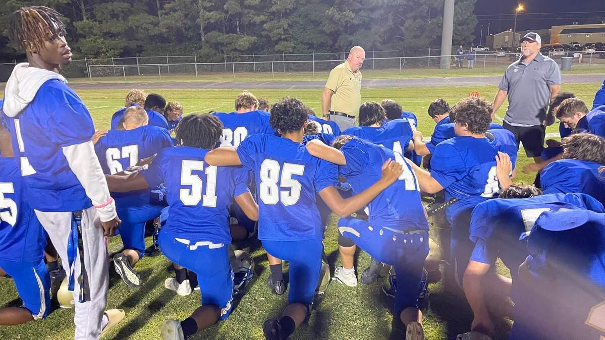 Lewisville players gather while head coach Will Mitchell gives a few remarks after Thursday night’s 48-8 loss to Lamar.