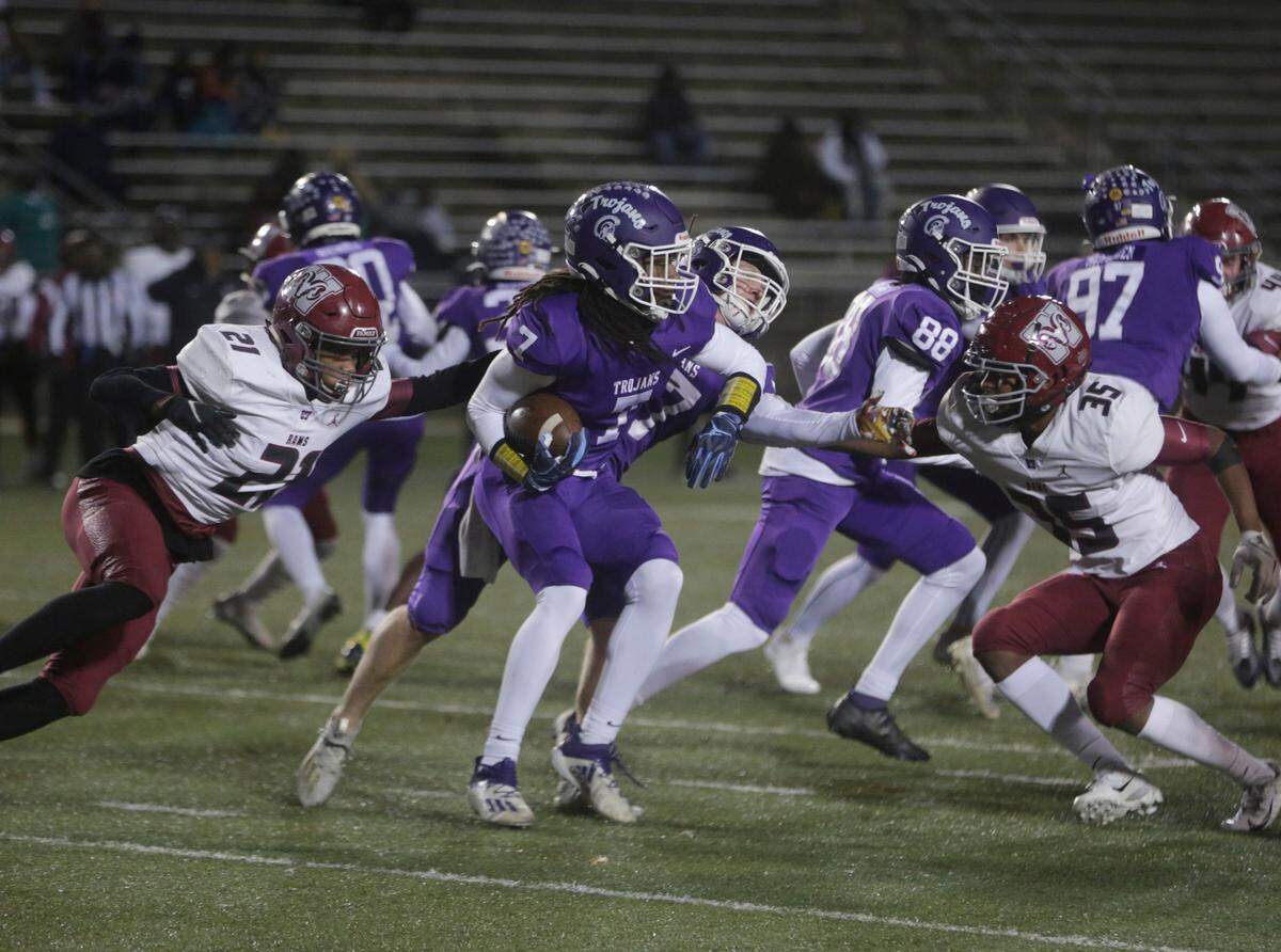 Northwestern’s Elijah Caldwell (7) tries to outrun Westside’s Tyler Galloway (21) and Trenton Galloway (35) Friday, Nov. 18 at the quarterfinals of the 4A state playoffs in Rock Hill.