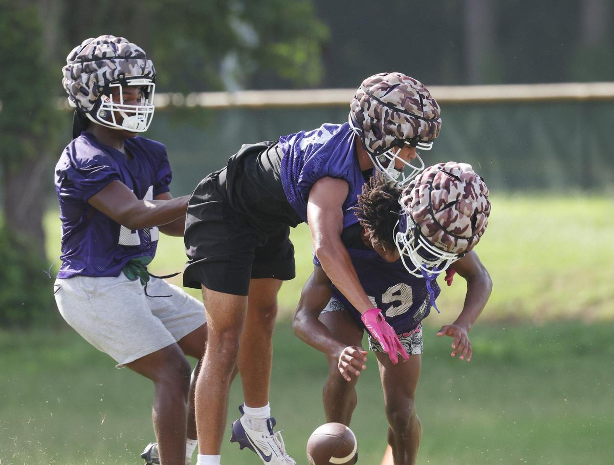 Northwestern varsity football players practice Friday at the school.