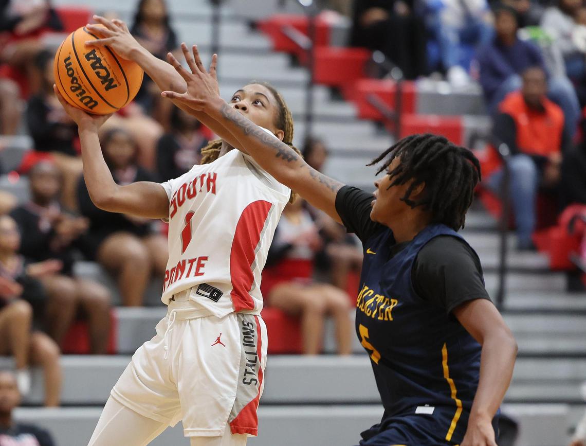 South Pointe’s Kaleigh Lucas, left, heads to the basket against Lancaster’s Eliza Baskins Tuesday in Rock Hill, S.C.
