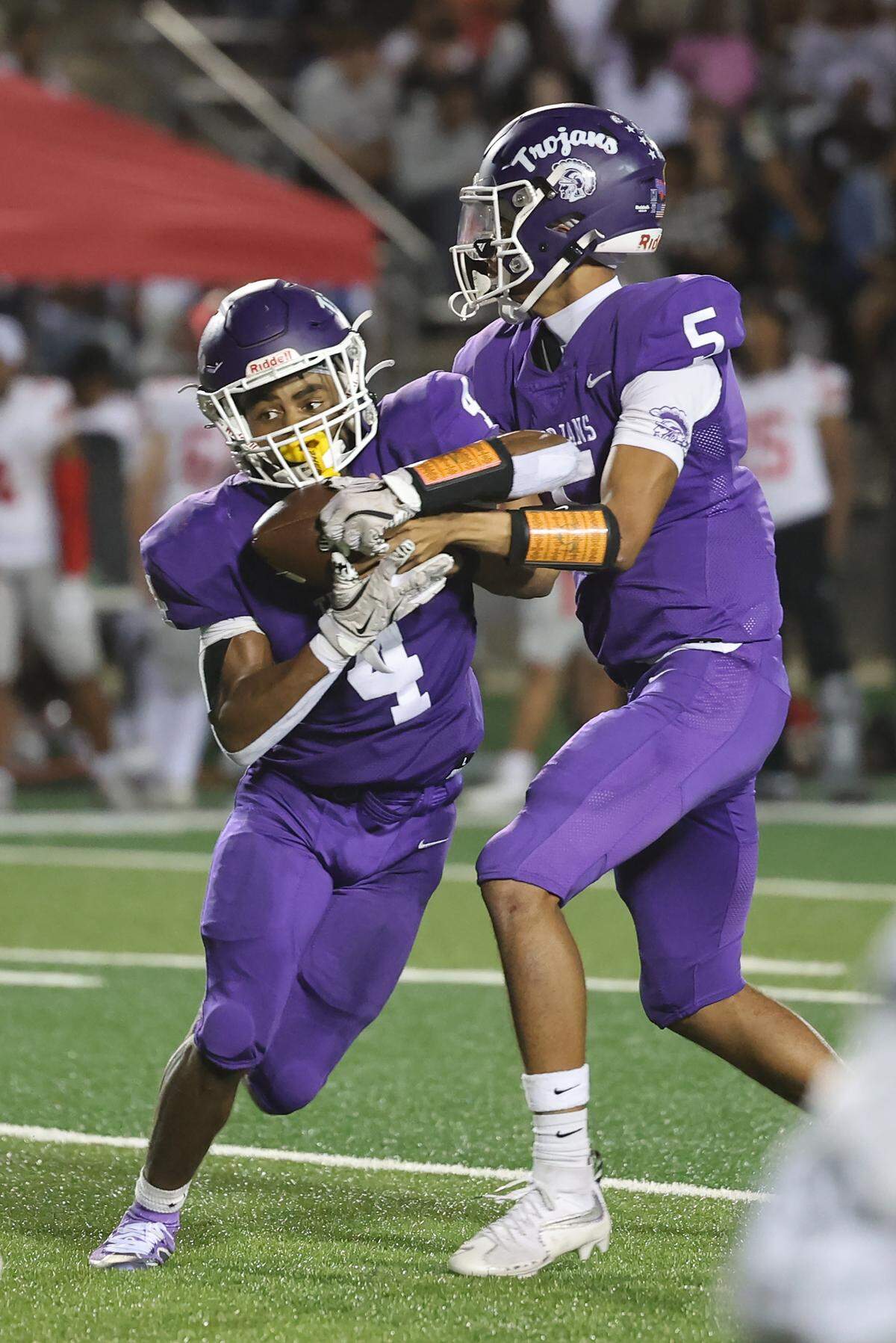 Northwestern's Xavier Means hands the ball to Nigel Smith during the Trojans’ mid-September game against South Pointe.