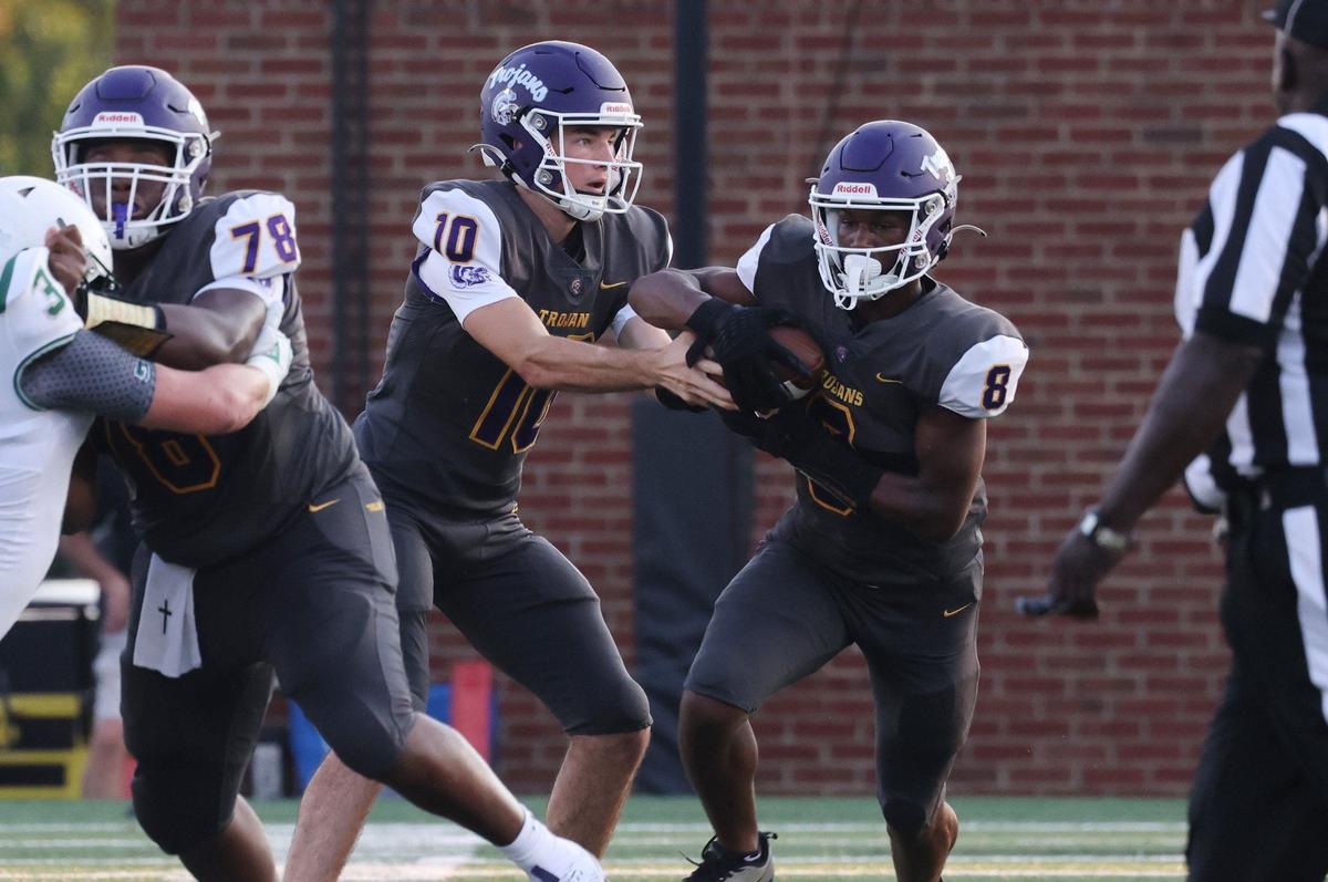 Northwestern’s Finley Polk hands off the ball to Zymier Gordon-Miles Friday at the WRHI Football City USA scrimmage in Rock Hill.