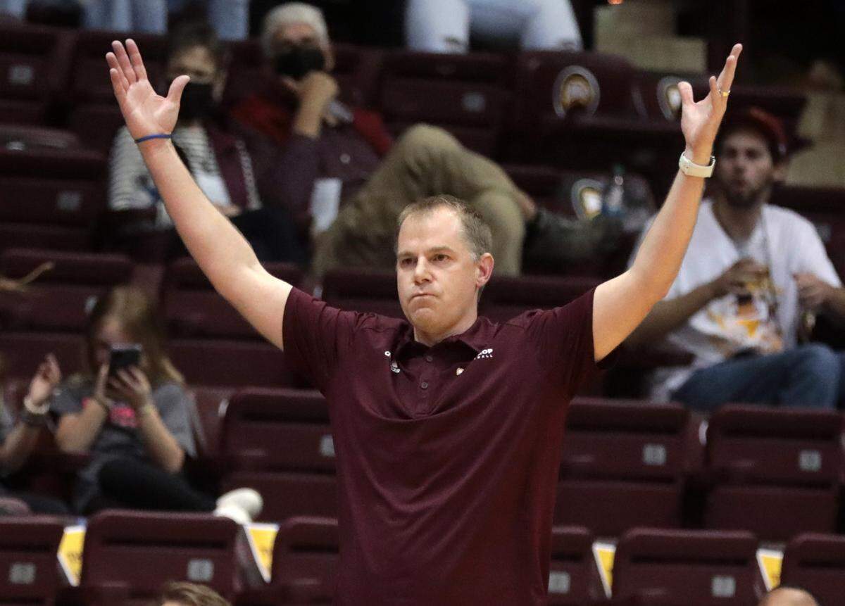 Winthrop University basketball coach Mark Prosser throws his hands up after a score.