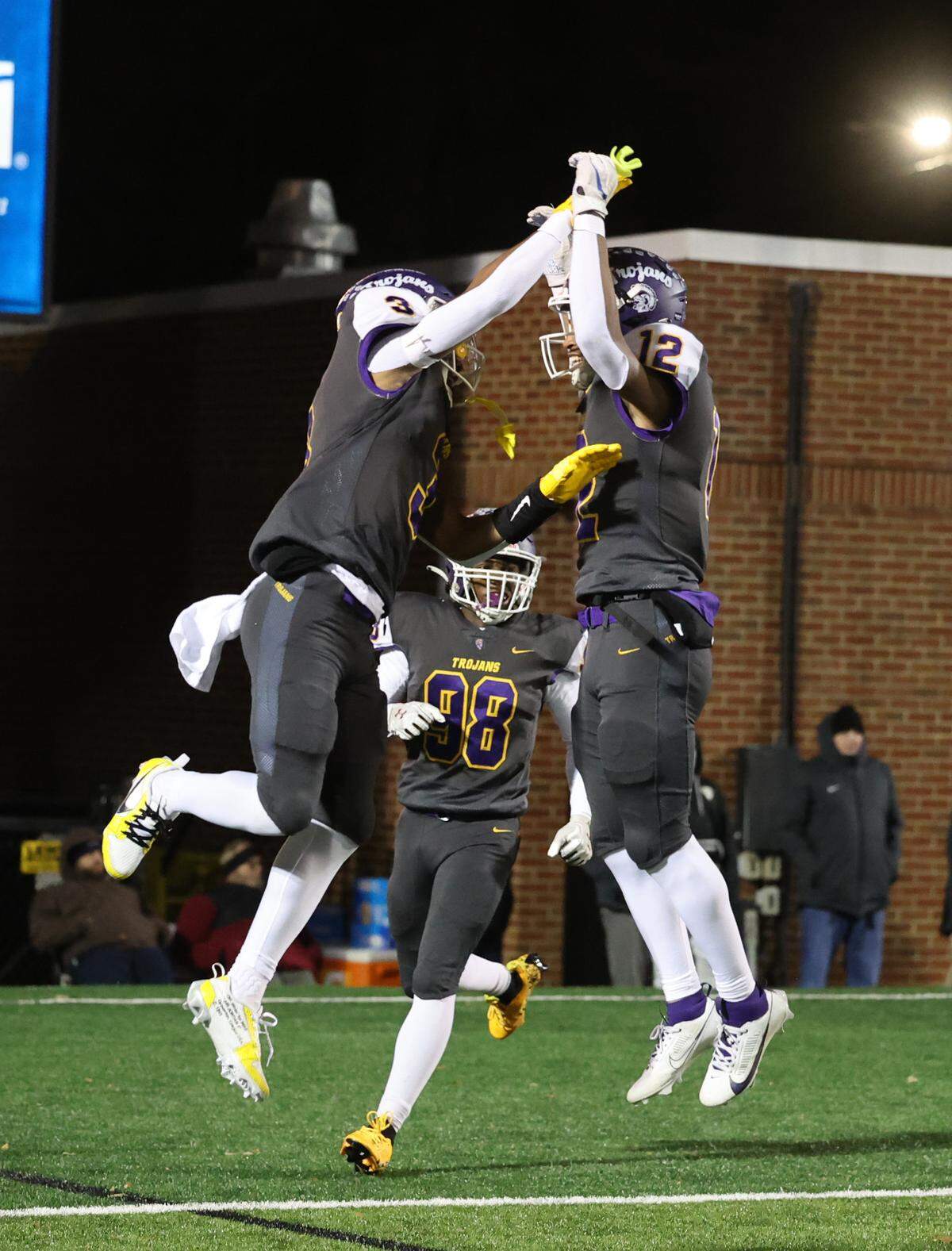 Northwestern’s Kameron Vance, left, Byron Dmitri Putman, II (98) and Jonathan Spurgeon celebrate after a touchdown Friday, Nov. 22, 2024 in Rock Hill, S.C.