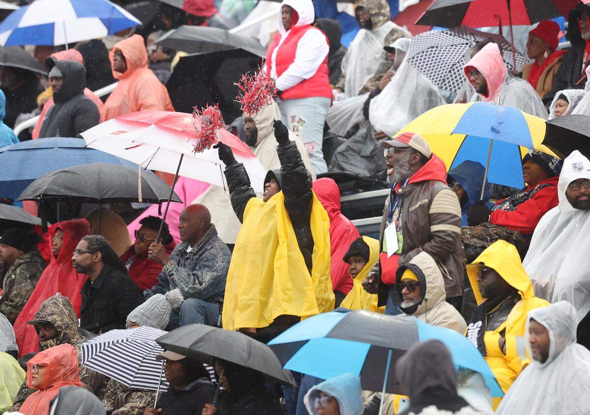 Fans at the SC High School League Class 4A football championship game on Saturday, Dec. 6, 2025 cheer for South Pointe High School in the rain.