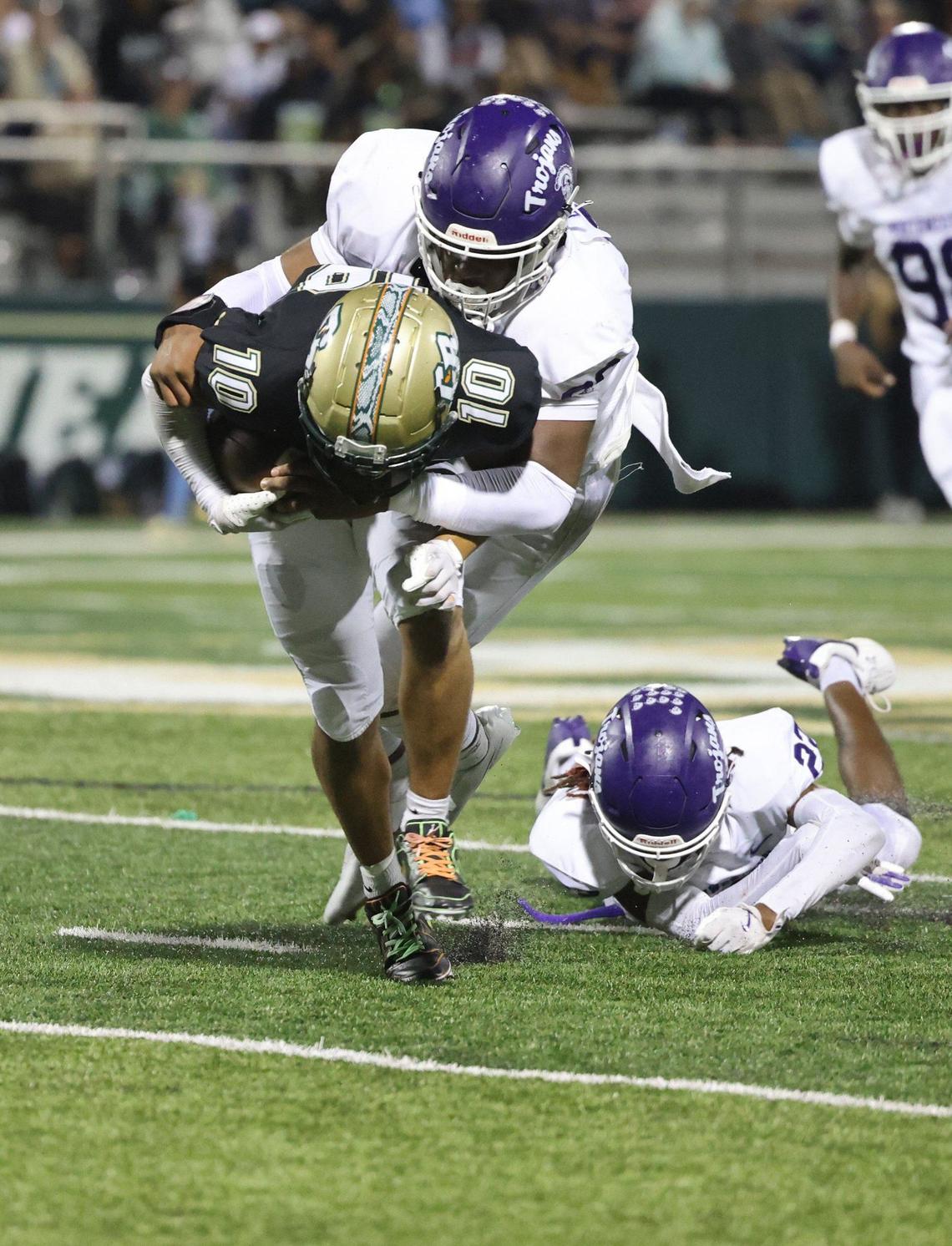 Northwestern’s Mason Grier pulls down Catawba Ridge’s Braylen Burgis as Northwestern’s Joshua Singleton (22) falls back Friday, Sept. 27, 2024 in Fort Mill, S.C.