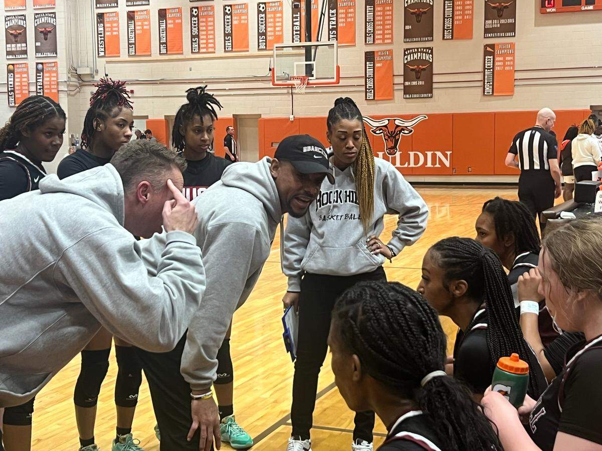 Rock Hill head coach Kenny Orr (grey sweatshirt, middle, black hat) and assistant coach Shannon Kuhl (grey sweatshirt, left, pointing to head) coaches up the team during the fourth quarter of the team’s 51-33 win over Mauldin.