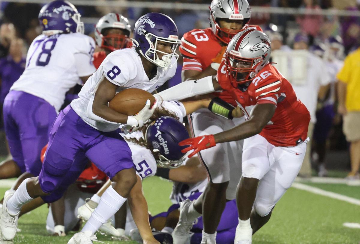 Northwestern’s Zymier Gordon-Miles (8) tries to avoid South Pointe’s Dequan Evans Friday as the Trojans and Stallions compete in Rock Hill.