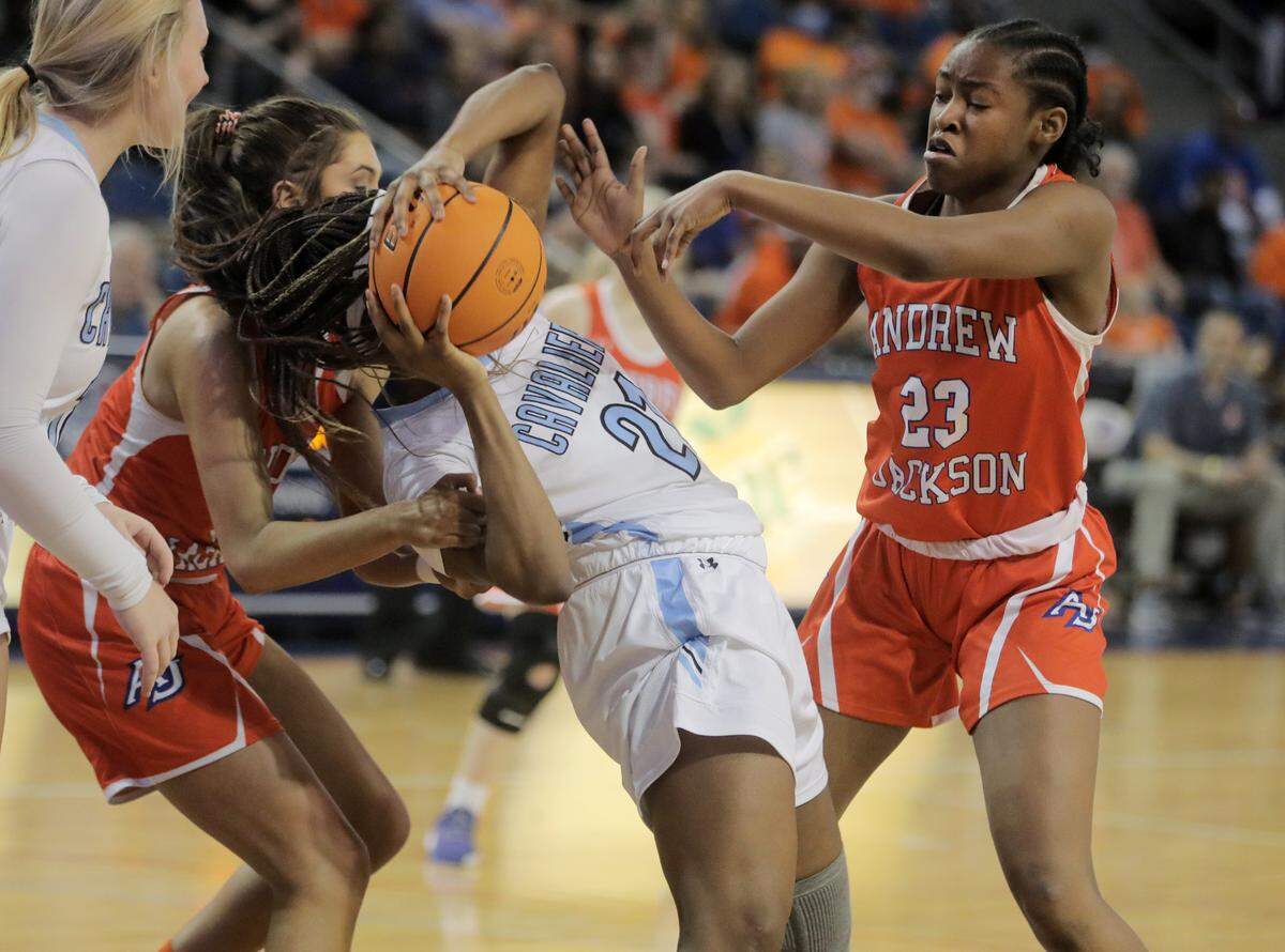 Christ Church’s Yasmene Clark, middle, fights for control of the ball with Andrew Jackson’s Annsley Vick, left, and Tamia Watkins, right.