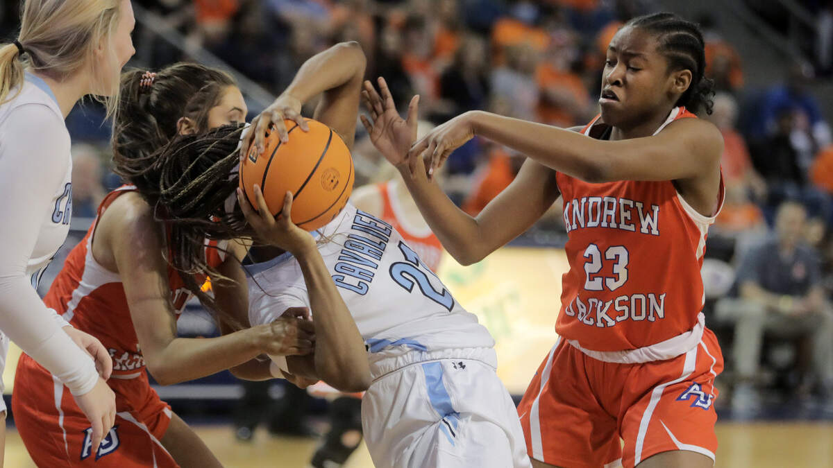 Christ Church’s Yasmene Clark, middle, fights for control of the ball with Andrew Jackson’s Annsley Vick, left, and Tamia Watkins, right.
