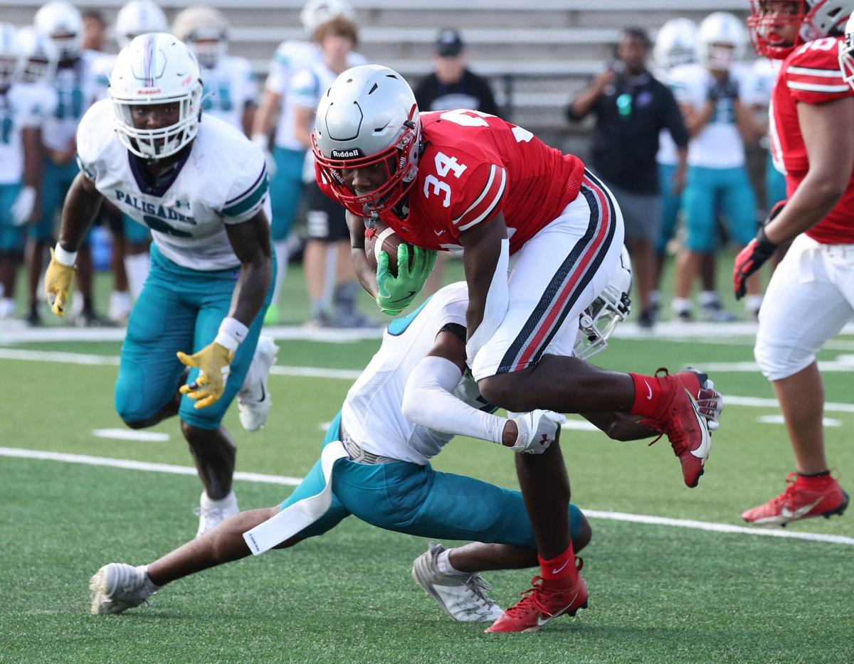 South Pointe’s Tyquan Brice is brought down by Palisades’ Elijah Bachiller Friday at the WRHI Football City USA football scrimmage in Rock Hill.