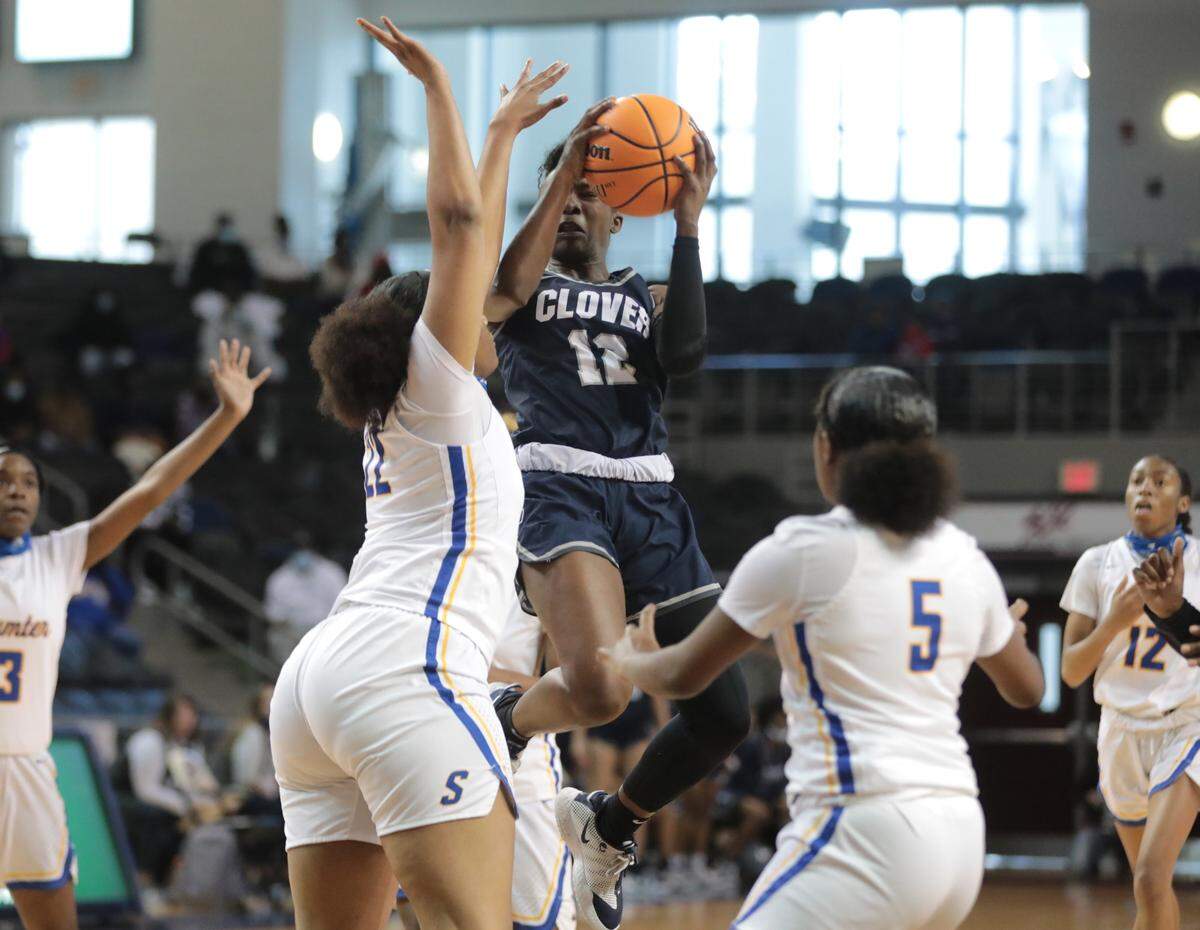 Clover’s Aylesha Wade heads to the basket surrounded by Sumter’s Layken Cox (22) and Alyssa Johnson (5) Saturday during the state championship game.