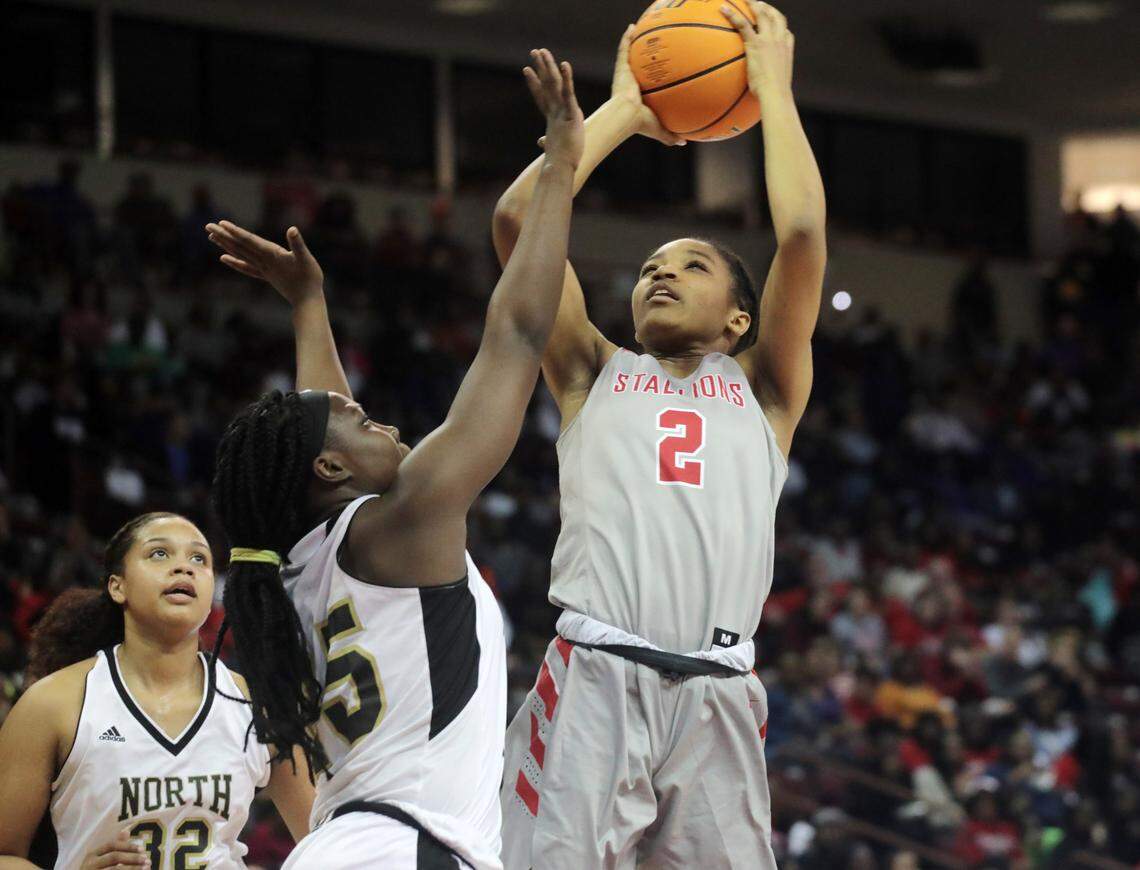 South Pointe’s Randi Neal puts up the shot around North Augusta’s Kiana Lee Saturday at the South Carolina High School League’s girls 4A basketball championship game in Columbia.