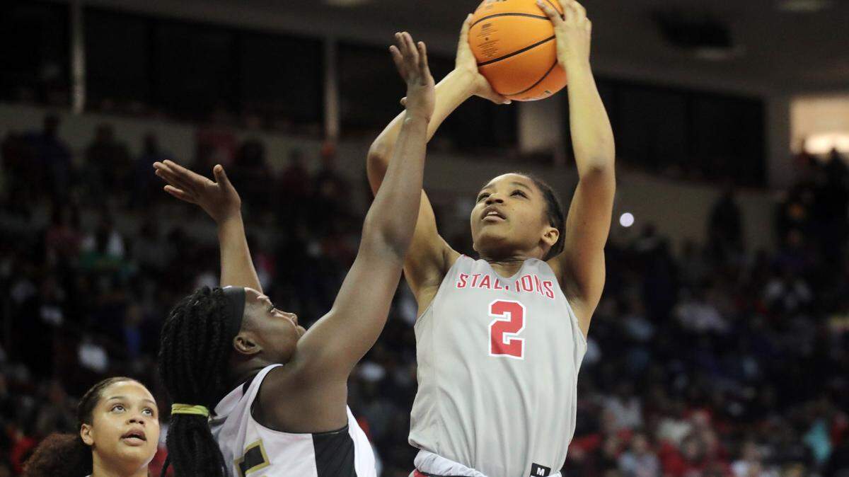South Pointe’s Randi Neal puts up the shot around North Augusta’s Kiana Lee Saturday at the South Carolina High School League’s girls 4A basketball championship game in Columbia.