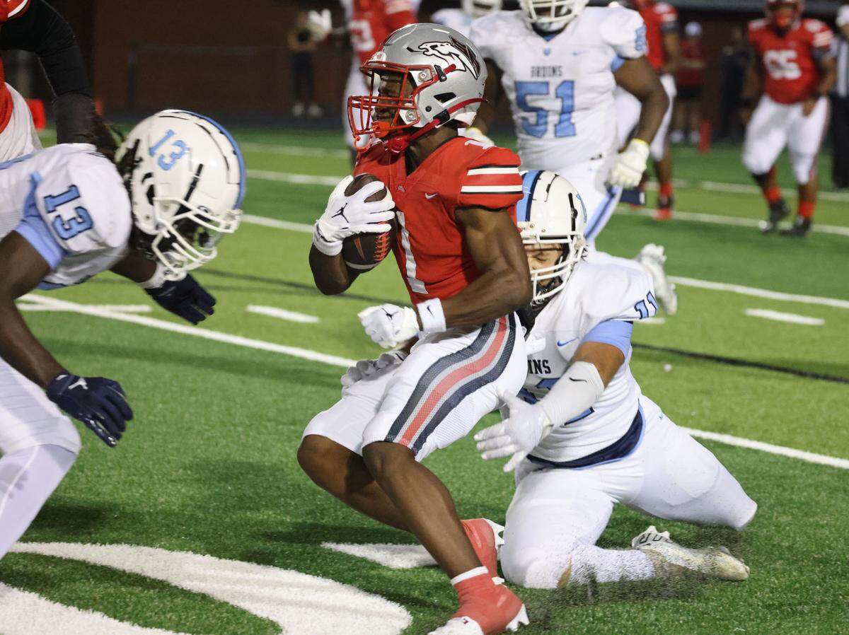 South Pointe’s Mason Picket-Hicks (1) carries the ball against South Florence’s Dirrick Goodman (13) and Noah Moore (11) in Rock Hill, S.C.