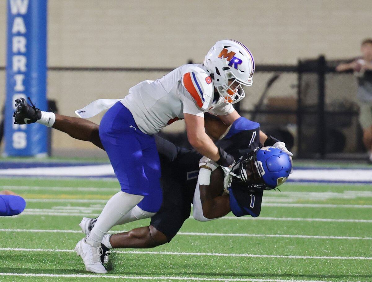 Marvin Ridge’s Brady Morgan tackles Omarion Davis near the endzone Friday in Indian Land
