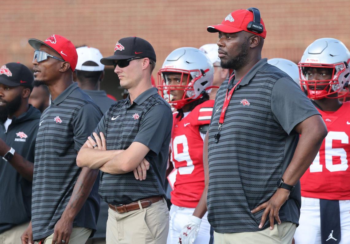 South Pointe High School head varsity football coach Bobby Collins, right, and staffers during a 2024 game.