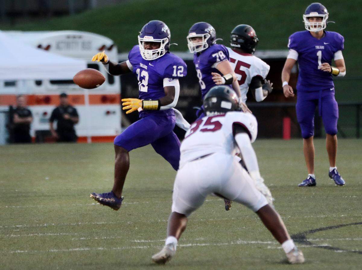 Northwestern’s Calique Cunningham (12) drops the ball as Rock Hill’s Dre’ Robinson (35) approaches.