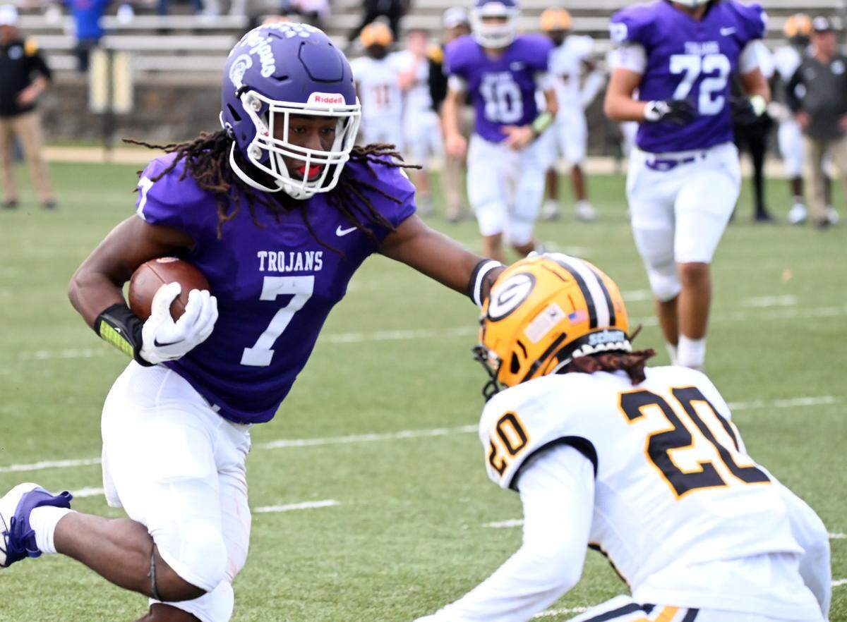 Northwestern’s Elijah Caldwell (7) tries to avoid Greenwood’s Jalance Saxon Saturday in Rock Hill.