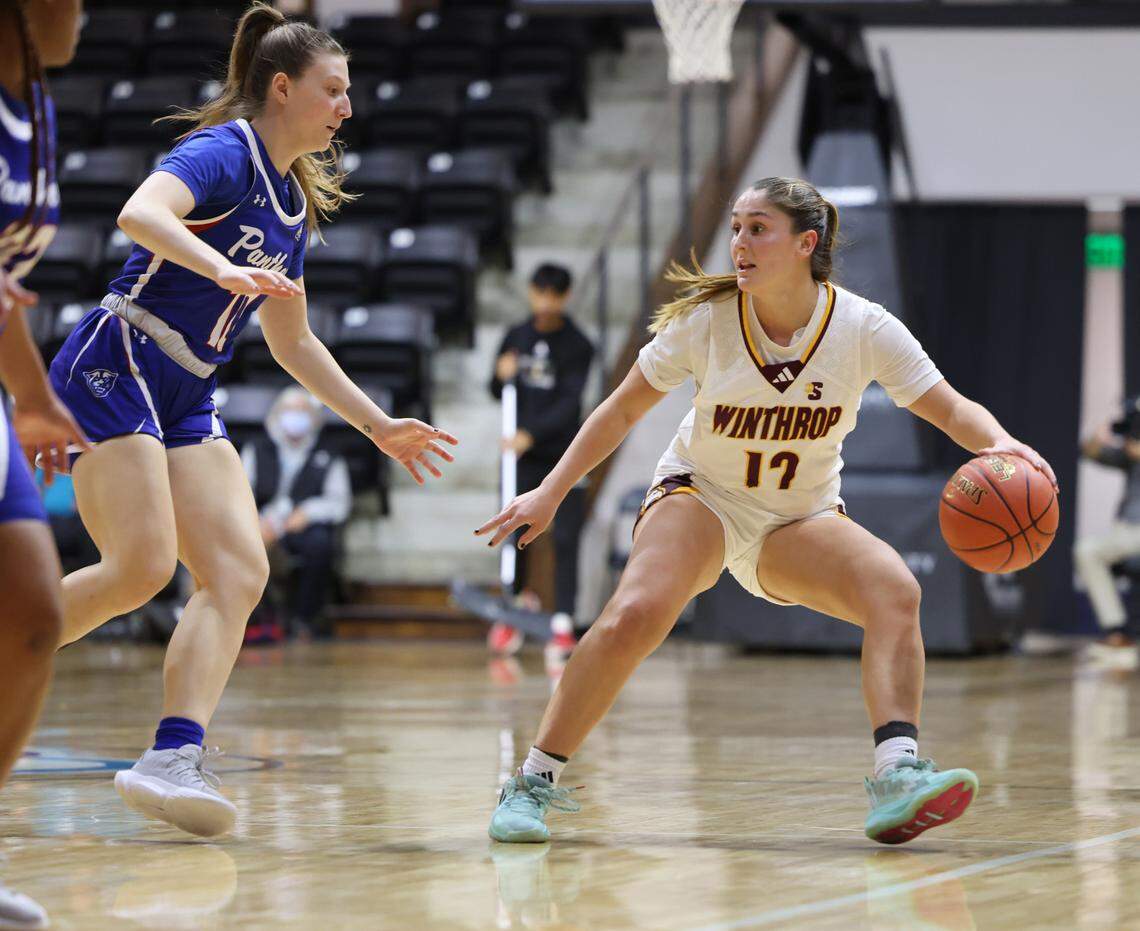 Winthrop’s Leonor Paisana looks for an opening around Georgia State’s Kamryn Dziak Thursday at the Rock Hill Sports and Event Center.