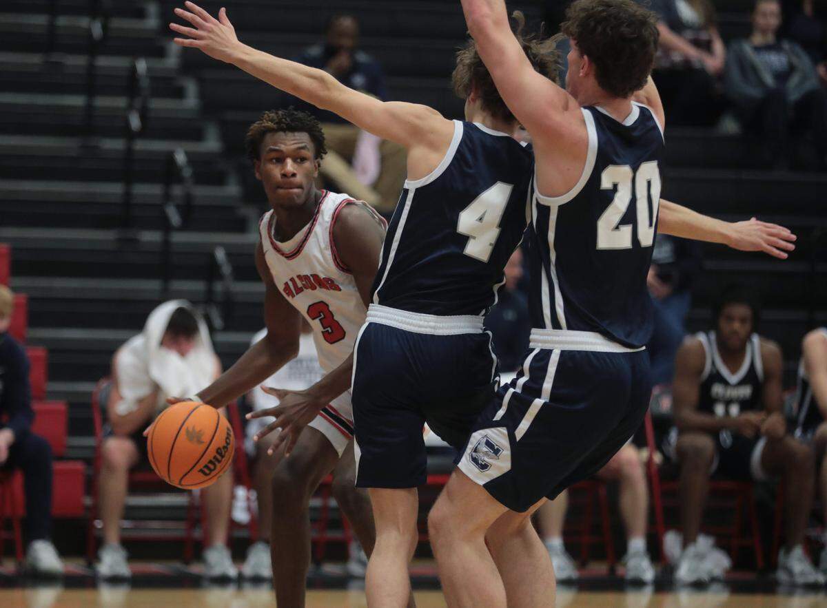 Nation Ford’s Quadier Hand (3) looks for an opening around Clover’s Nicky Glenn (4) and Jackson McMullen (20) Friday as the Falcons and Blue Eagles compete in Fort Mill.